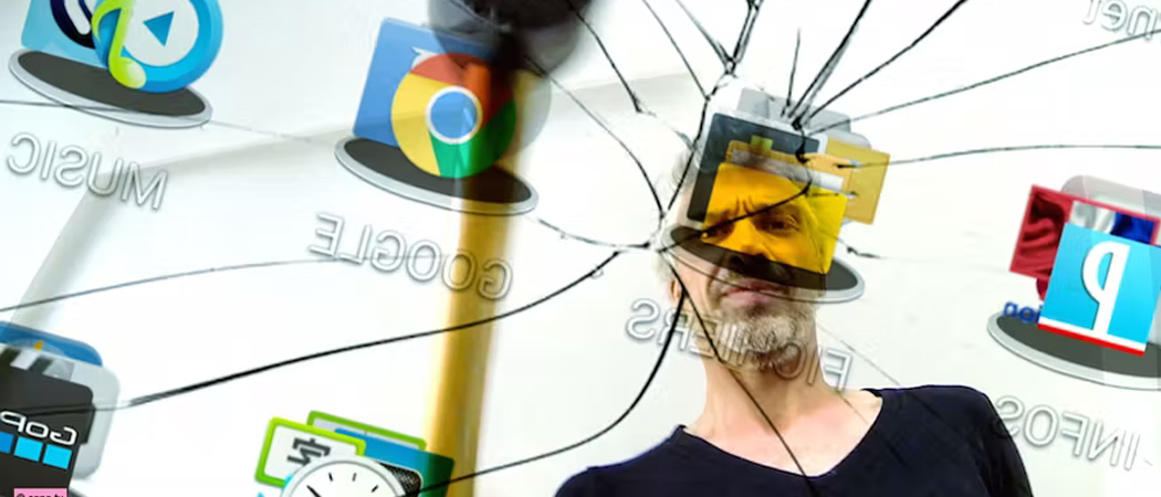 Man reflecting while looking at a broken device screen, symbolising the impact of constant connectivity and the need for a digital detox.