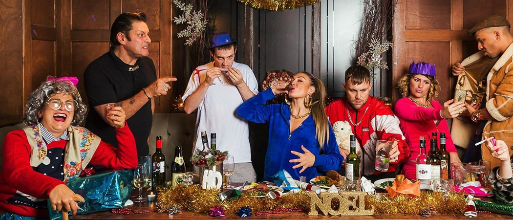 Chaotic family Christmas dinner scene with emotional expressions, symbolising holiday stress and connection.