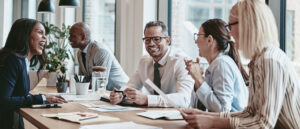 Office team collaborating to implement psychosocial risk controls and strengthen workplace psychological safety.