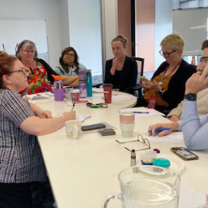 Get Mentally Fit facilitator delivering a communication skills workshop for Carers Queensland Logan staff, focusing on collaboration and effective team communication.