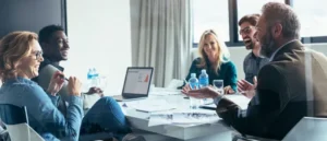 A Bridge Leader conducting a team meeting to proactively mitigate psychosocial WHS risk and improve psychological safety.