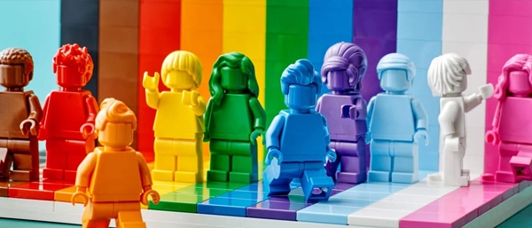 Colourful rainbow Lego figurines representing diverse workplace characters gathered in a circle, symbolising a supportive and inclusive work culture.