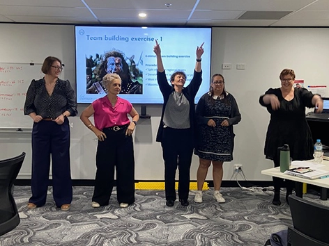 Carers Queensland managers participating in an interactive team-building activity during a Get Mentally Fit training session.