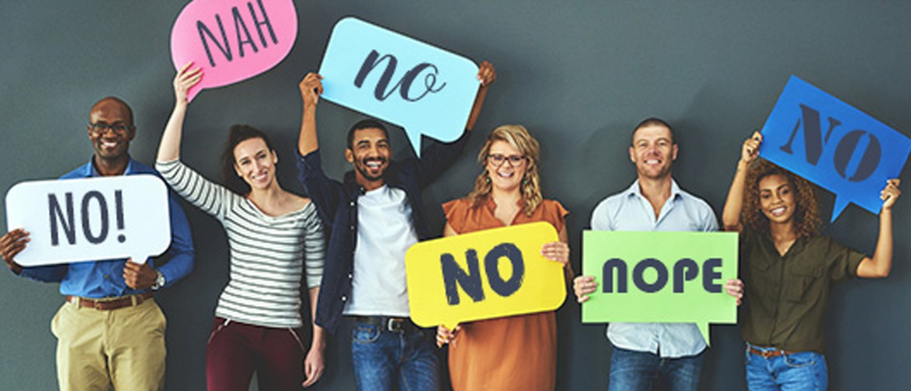 Professionals holding colourful “No” signs to promote healthy workplace boundaries.