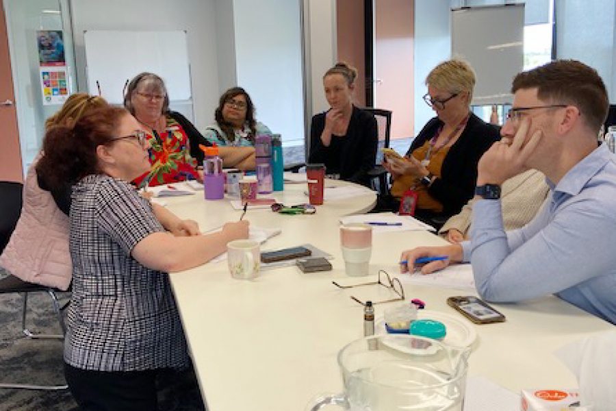 Get Mentally Fit facilitator delivering a communication skills workshop for Carers Queensland Logan staff, focusing on collaboration and effective team communication.